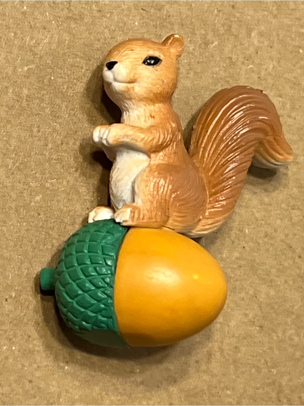 Squirrel Figure Sitting On Acorn
